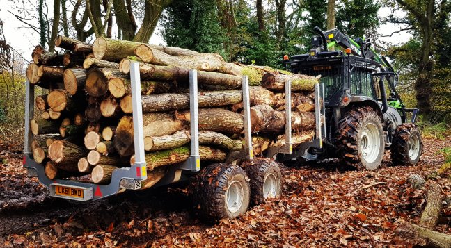 Valtra forestry tractor with roof mounted crane and botex timber trailer